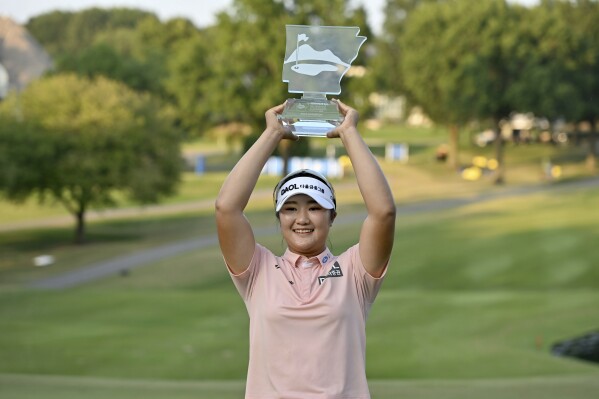 Hae Ran Ryu holds up the trophy after wining the LPGA Walmart NW Arkansas Championship golf tournament, Sunday, Oct. 1, 2023, in Rogers, Ark. (AP Photo/Michael Woods)