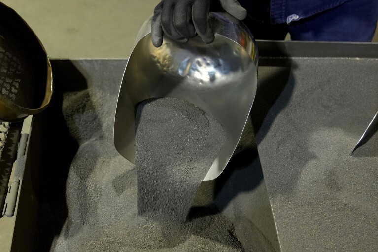 A worker shows sample of nickel matte at PT Vale Indonesia's processing plant in Sorowako, South Sulawesi, Indonesia, Tuesday, Sept. 12, 2023. (AP Photo/Dita Alangkara)
