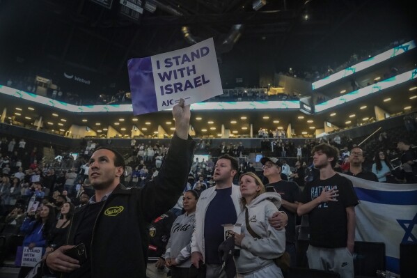 Fans show support for Israel as they stand during the national anthem before a preseason NBA basketball game between Israel's Maccabi Ra'anana and the Brooklyn Nets, Thursday, Oct. 12, 2023, in New York. (AP Photo/Bebeto Matthews)