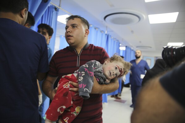 A Palestinian child wounded in Israeli strikes is brought to Shifa Hospital in Gaza City on Wednesday, Oct. 11, 2023. (AP Photo/Ali Mahmoud)
