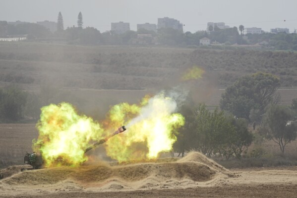 An Israeli howitzer fires at the Gaza Strip from the south of Israel on Thursday, Oct. 12, 2023. (AP Photo/Ohad Zwigenberg)