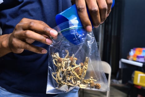 A vendor bags psilocybin mushrooms at a cannabis marketplace in Los Angeles.