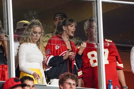 Taylor Swift laughs while talking to Ed Kelce, Travis Kelce’s father, during the second half of the Thursday’s game.