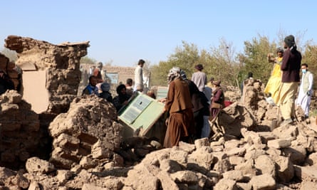 Men clear debris after an earthquake in Zindah Jan district, Herat province