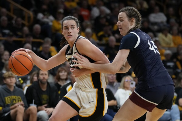 Iowa guard Caitlin Clark drives past Fairleigh Dickinson forward Lilly Parke (45) during the second half of an NCAA college basketball game, Monday, Nov. 6, 2023, in Iowa City, Iowa. (AP Photo/Charlie Neibergall)