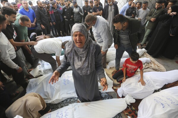 Palestinians mourn their relatives killed in the Israeli bombardment of the Gaza Strip in Rafah, Tuesday, Nov. 7, 2023. (AP Photo/Hatem Ali)