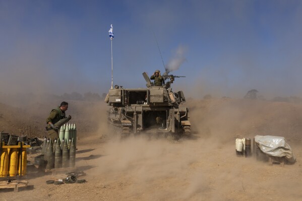 An Israeli mobile artillery unit fires a shell from southern Israel towards the Gaza Strip, in a position near the Israel-Gaza border, Monday, Nov. 06, 2023. (AP Photo/Ohad Zwigenberg)