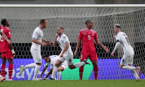 Shon Weissman celebrates his Israel goal that made Switzerland wait for a Euro 2024 spot, as Manuel Akanji shows his disgust.